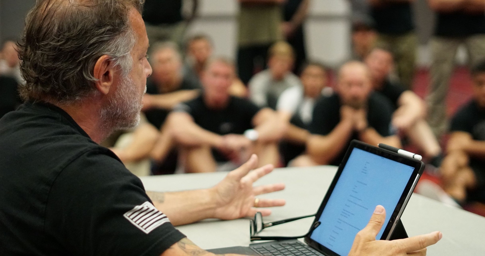 Coach Tony Blauer coaching, explaining a point from his tablet